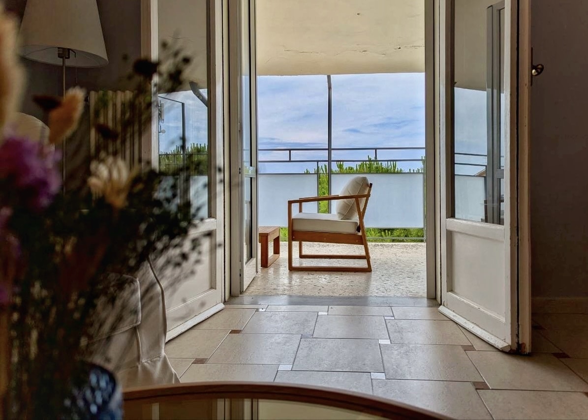 French doors opening onto the wrap-around balcony